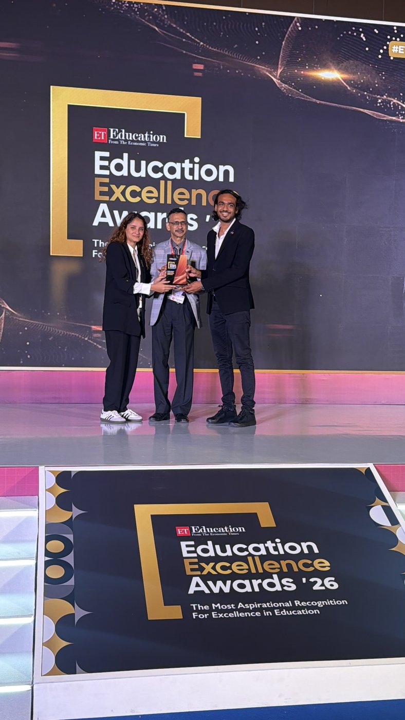 Aditya Poddar receiving the Economic Times Education Excellence Award on stage