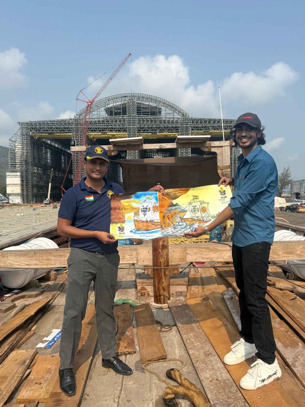 Aditya Poddar on the deck of INSV Kaundinya at Karwar, handing over the children's painting